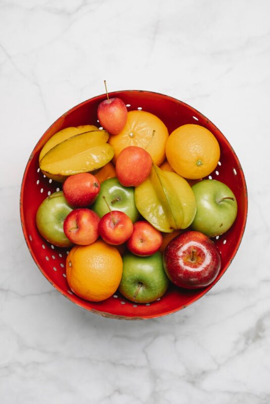 ripe fruits placed in red bowl